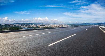 Asphalt highway road and city skyline with green mountains natural landscape in Shenzhen. Panoramic view.