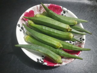 Lady finger : Graceful curves, gentle allure, poised elegance, captivating presence, timeless beauty, refined charm, epitome of femininity.