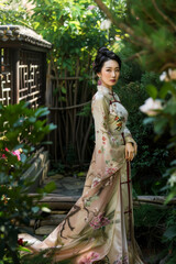 Elegant Chinese Asian woman posing in a lush garden, dressed in a flowing silk qipao adorned with intricate floral embroidery, epitomizing grace and beauty in traditional attire