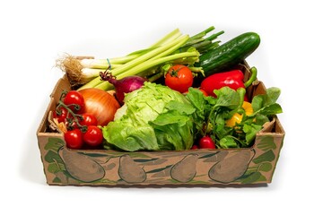 Box packed full of fresh vegetables isolated on white