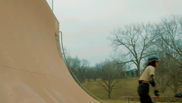 Skating enthusiast enjoys the Corey Lawrence halfpipe, also known as the Vert Ramp, in Lawrence, KS. The essence of leisure and free time through the art of skating, with a touch of slow-motion magic.