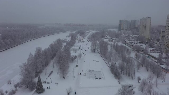 Frozen city concept. Gray and dull weather. Aerial view of park along the Moscow canal in winter. Park of Dolgoprudny city in winter
