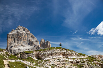 Stunning view of a tourist enjoying the view of the Tre Cime Di Lavaredo, Dolomites, Italy. - 775642364