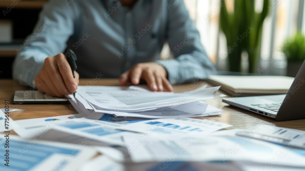 Poster documents such as loan applications, credit reports, and financial projections being reviewed and pr