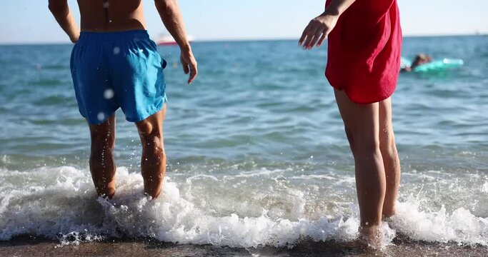 Woman and man legs jump on sea beach. honeymoon and happy tourist on vacation