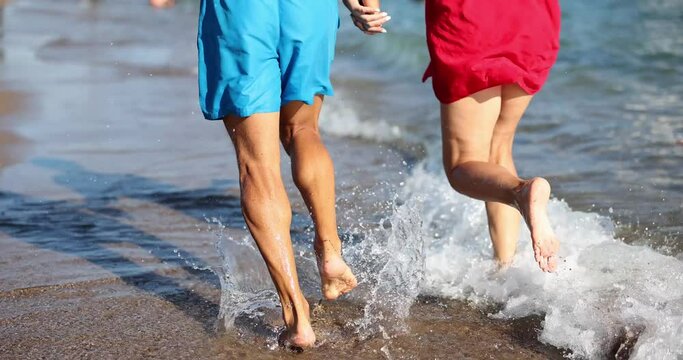 Walking and jogging on beach of loving couple. Couple on beach runs along sea beach joy happiness and honeymoon emotions