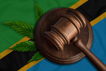 Judges gavel and marijuana leaf on the Tanzania flag background. Concept of legalization of marijuana.