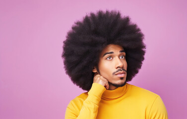 Fototapeta na wymiar Funny portrait of a thoughtful afro american man with an expressive face on pastel background