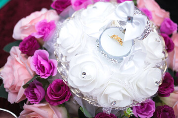 Stylish bride wedding ring and flowers. Engagement. Luxury marriage and wedding accessory concept.