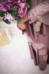 Bride hand with beautiful ring on wedding dress.