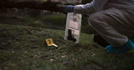 Crime scene, gun and investigator with evidence outdoor for forensics, analysis and investigation...