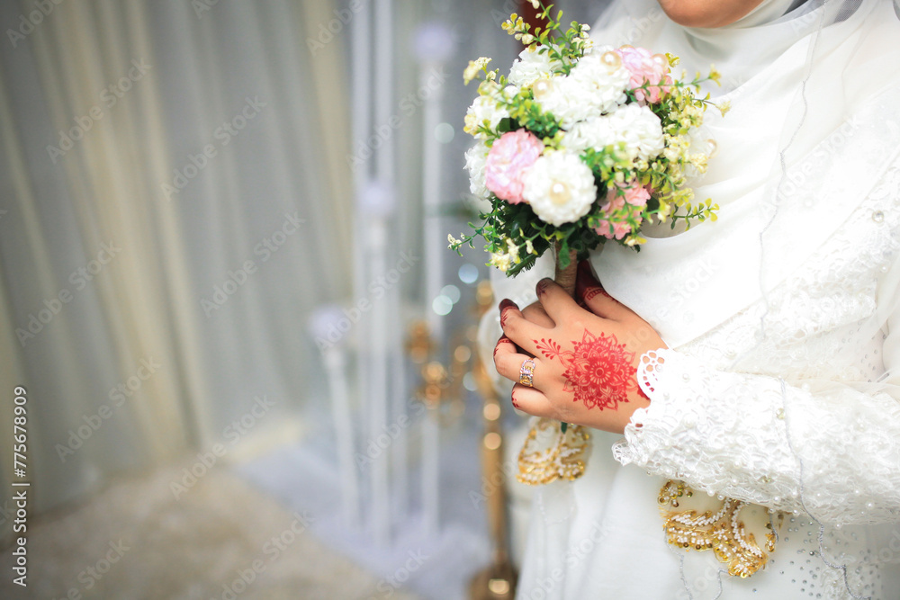 Wall mural Beautiful wedding bouquet in hands of the bride. Trendy and modern wedding flowers.