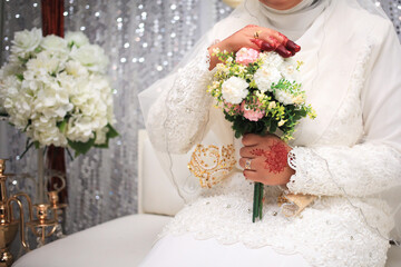 Beautiful wedding bouquet in hands of the bride. Trendy and modern wedding flowers.