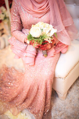 Wedding bride holding bouquet of flowers. Close up and selective focus.