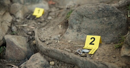 Closeup, evidence marker and forensic for investigation at crime scene with keys on ground or...