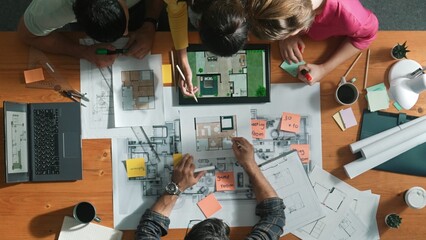 Top down view of engineer planning and writing at blueprint. Architect team working together to...