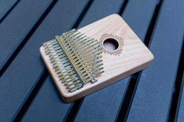 Close up of a thumb piano or kalimba on a wooden table.