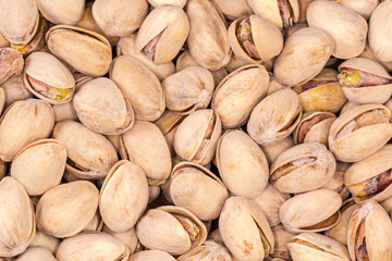 Background of the roasted salted pistachio nuts close-up