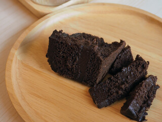 Pieces of delicious chocolate cake in a wooden tray  