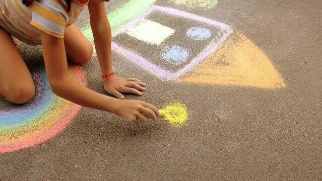children on the street draw with chalk. selective focus.