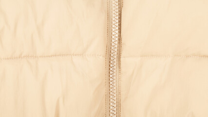 Close-up on puffer jacket texture with zipper. Fabric background