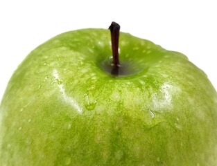 Closeup photo of a fresh green apple, isolated on white background.