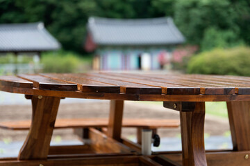 View of the wooden table and bench in the farm of the Buddhist temple