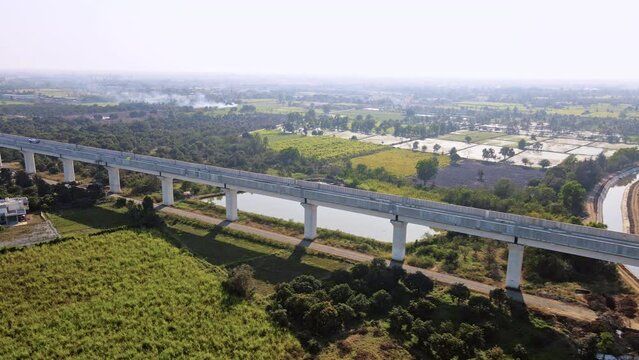 Aerial View: Mumbai to Ahmedabad Bullet Train Bridge Construction Over Surat Mumbai Highway. India's biggest project of HSRC bullet train under construction. Developing India concept.