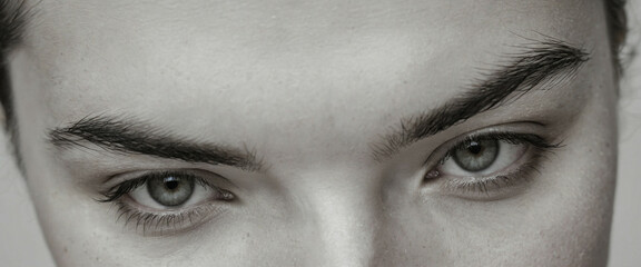 close-up of a person's face, focusing on their eyes. panorama, banner with copy space for text