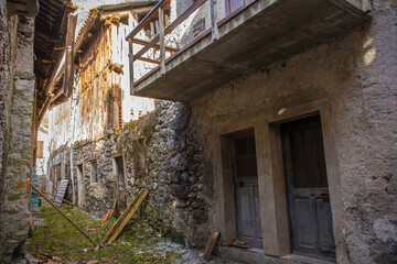 Fototapeta na wymiar Derelict old houses in the historic hill village of Timau in Udine Province, Friuli-Venezia Giulia, North East Italy. Part of the Paluzza municipality