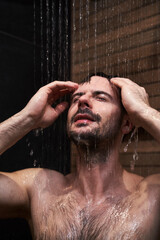 Caucasian man taking shower at home