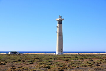 Faro de Morro Jable, Lighthouse on Morro Jable beach on Jandia peninsula in sunrise light,...