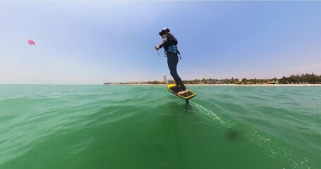 Kite Foiling (HydroFoil Kite Surfing) In Mui Ne, Vietnam; Low Angle Follow Cam POV. - Powered by Adobe