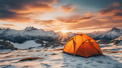 Tent on a snowy mountain. Mountains at sunrise