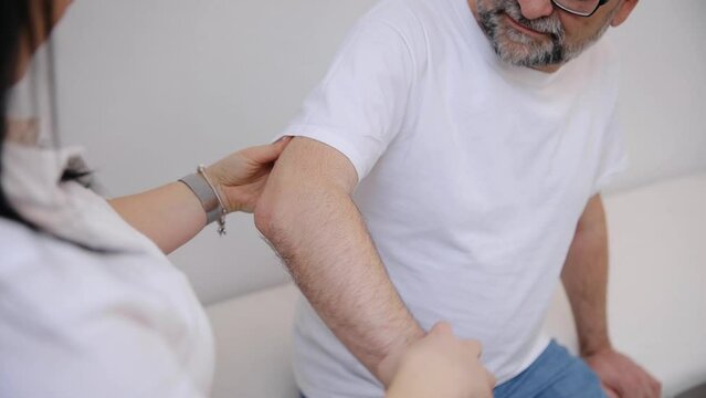 The doctor counsels the patient about pain in the muscles of the arms and elbows. The office syndrome problem physical therapy diagnostic concept