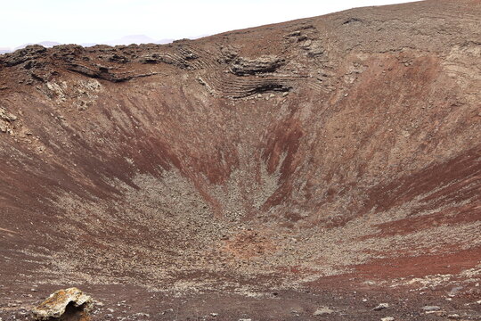 Dramatic volcanic red deserted crater of Calderon Hondo volcano near to Corralejo, Fuerteventura. Canary Islands