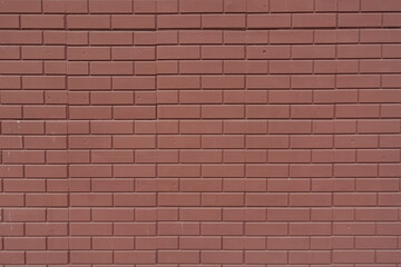 Texture of reddish brown painted brick veneer wall