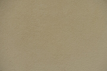 Backdrop - wall with coarse light beige roughcast finish