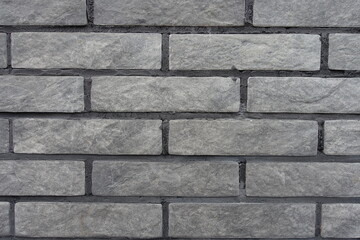 Close view of gray artificially aged brick veneer wall