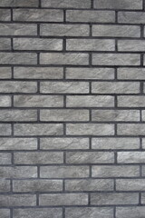 Loft style gray artificially aged brick veneer wall