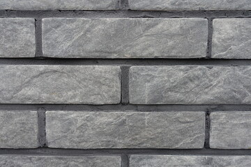 Macro of gray artificially aged brick veneer wall