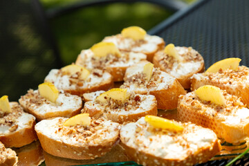 Canapes and Cocktail Snacks: Crostini with Cream Cheese, Apple Slices and Dried Fruits Appetizer - Catering Food in Outdoor Banquet Table