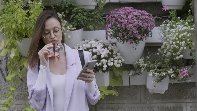 Business woman eating chocolate in the street