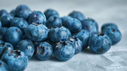 Close-up of fresh organic blueberries with vibrant juicy texture on a textured surface