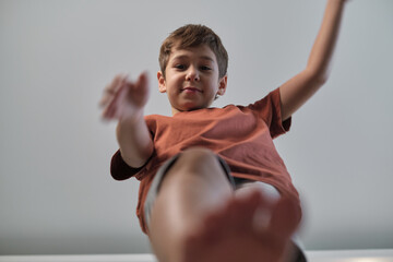 Child extends a helping hand, shot from below. Illustrates the concept of support and the natural inclination to assist others.