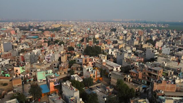 A drone shot of a densely populated neighborhood in Delhi, India's capital, showing the smog and pollution that plagues Indian cities.