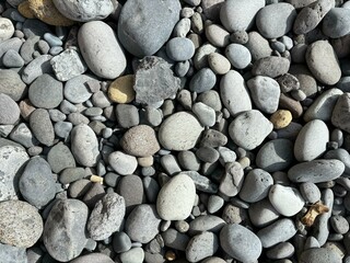 Gray color pebbles isolated close-up on a wild beach in El Medano, Tenerife, Canary Islands, Spain