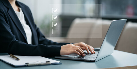 Businesswoman using tablet to do online checklist survey, doing assessment online survey answer test questions Digital form.