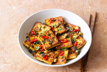 Fried tofu with peppers, garlic and herbs. Vegetarian food. Healthy eating. Diet.