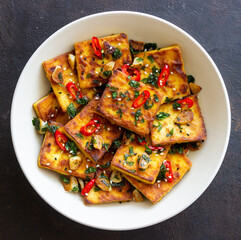 Fried tofu with peppers, garlic and herbs. Vegetarian food. Healthy eating. Diet.